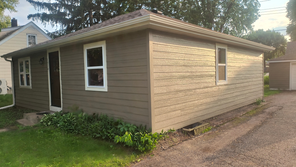 By the gutters sending the water to the other side of the house - our customer's driveway will be free from pooling.